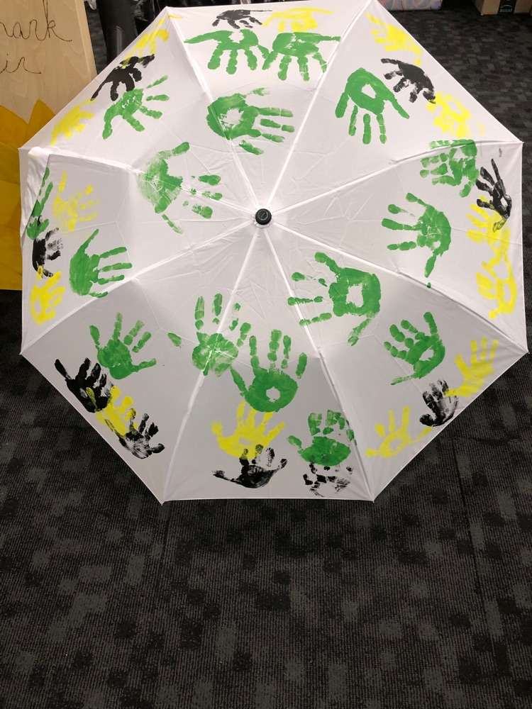 AES students put their handprints on an umbrella for Mrs. Craver.